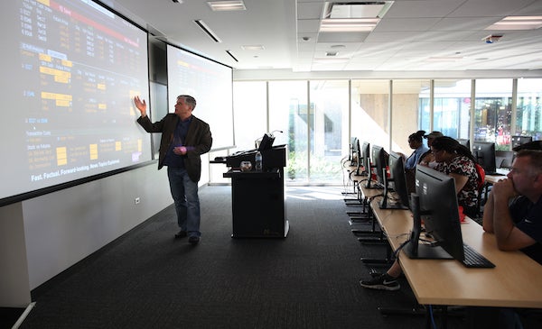 instructor at front of room teaching