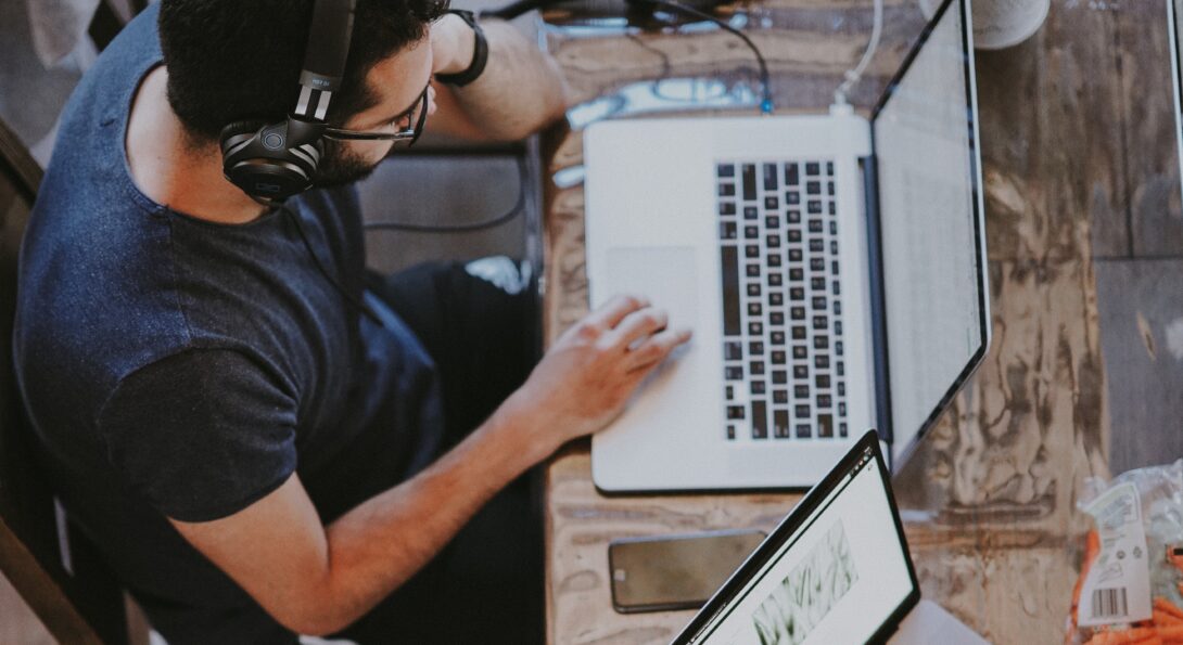 person on headphones chatting while on computer